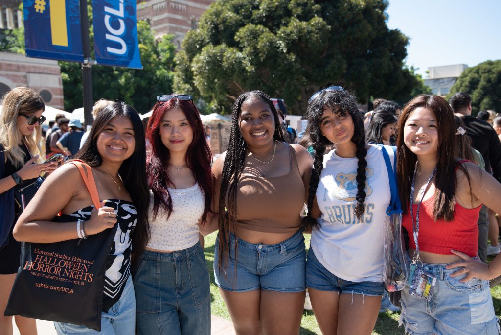 Amia Dauis (left) poses for a photo with friends at the Enormous Activities Fair. As a first-year psychology student, she hopes to find pre-med clubs that interest her. Photo by Julia Gu/BruinLife.