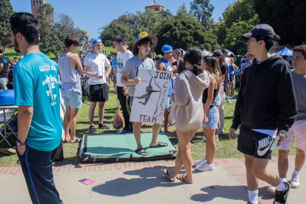 Allison McCabe and Jordan Wanigaratne talk to the Climbing Club about possibly joining. Many clubs, like the Climbing Club, design posters and flyers to catch the eyes of students walking by. Photo by Juan Cesar Perez/BruinLife.