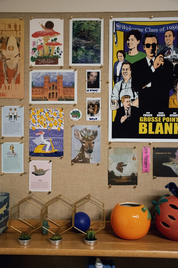 The range and vibrancy of colors above the desk are highlighted by the various posters, pictures and pots which add a significant warmth to Moore's dorm that is unmistakably unique to her.