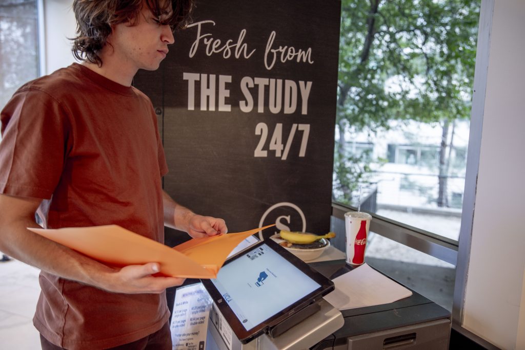 Wesley Loughran, a second-year undeclared humanities student from the Shenanigans Comedy Club at UCLA, prints a script for the club’s next digital sketch at the Study at Hedrick. Among other things, the club posts low-budget sketch comedies on YouTube and Instagram.