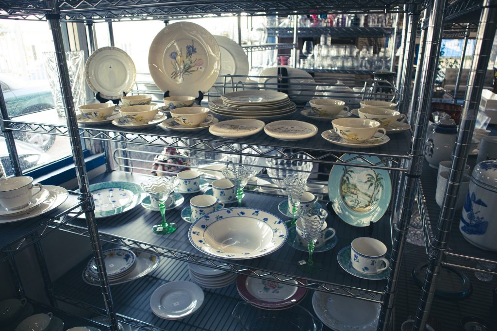 Shelves of plates and other dishware lie near a window in the store. Whether you are looking for a particular item or just browsing, you can be sure to find something that catches your eye at the UCLA Thrift Shop.