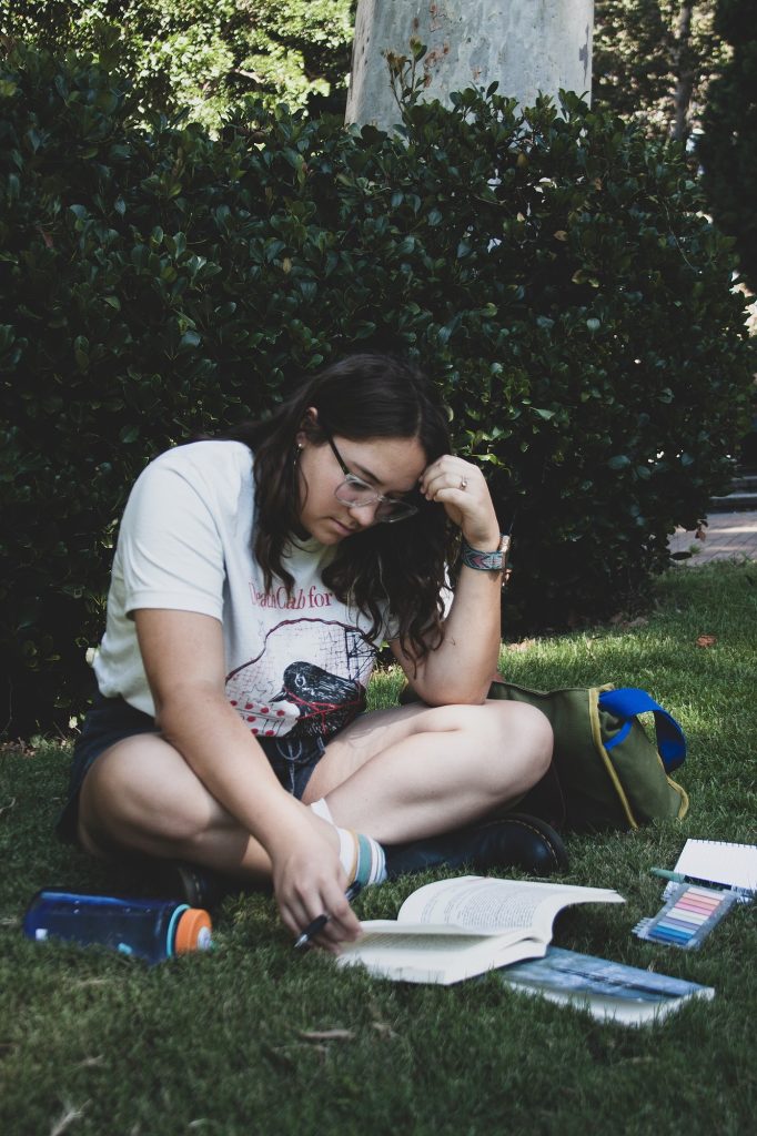 Danyel Taylor, a fourth-year student majoring in English, is reading "The Letters of Emily Dickinson" by Emily Dickinson in the Sculpture Garden. “I like to be outside, I need the sun to be happy," Taylor said.