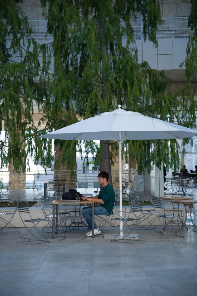 A student studies under the willow trees in the Museum Courtyard. The Center has a tranquil outdoor environment, filled with fountains and cafés where you can spend your afternoon. Photo by Katelyn Michel/BruinLife.