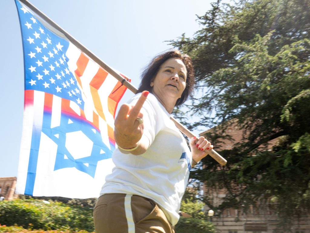 A pro-Israel protester gives the middle finger to one of BruinLife's reporters. Photographed by Finn Martin/BruinLife.
