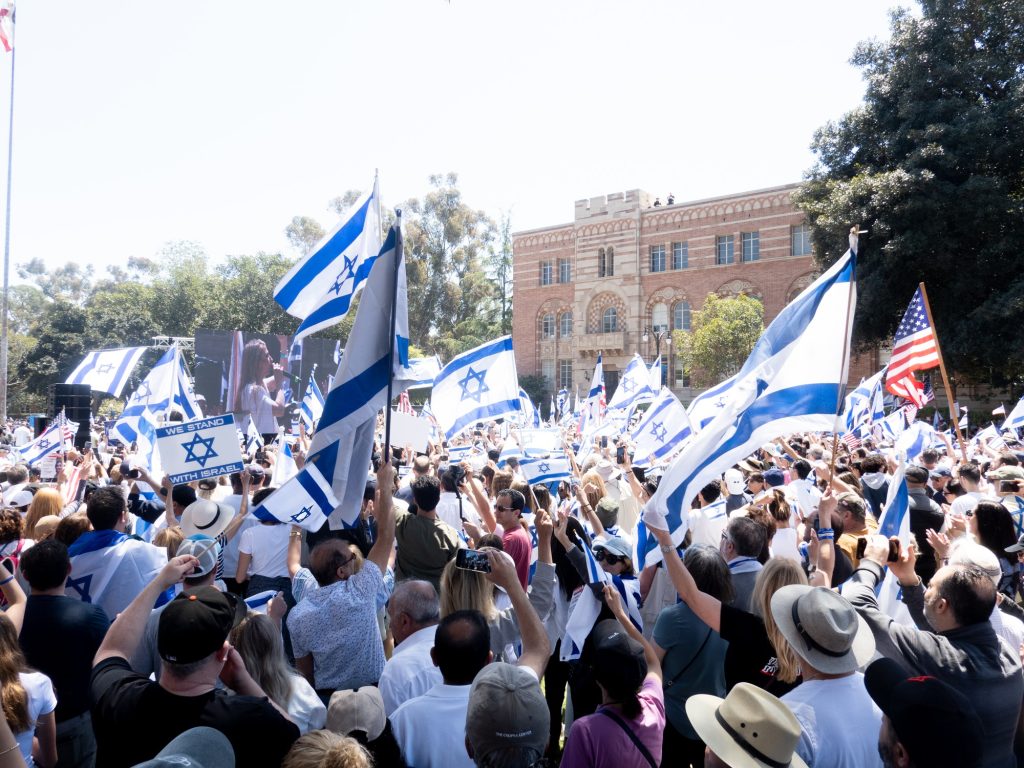 Pro-Israel protesters crowd Dickson Plaza, waving both the flag of Israel and the United States. Organized by the Israeli American Council, the pro-Israel protest centered around a benefit concert, most prominently playing the Star Spangled Banner. Photographed by Finn Martin/BruinLife.