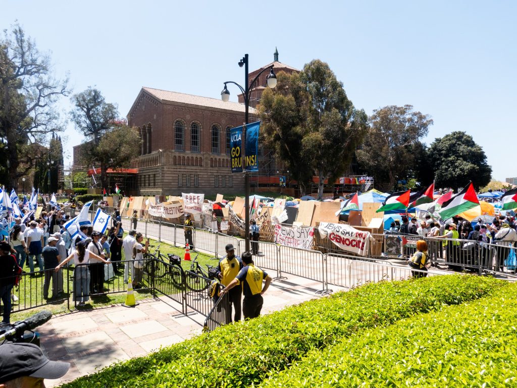 From 11 a.m. to 1 p.m. on April 28, pro-Israel protesters occupied the Dickson Plaza lawn neighboring the pro-Palestine encampment.  Campus security forces manned passageways between the two groups. Photographed by Finn Martin/BruinLife.
