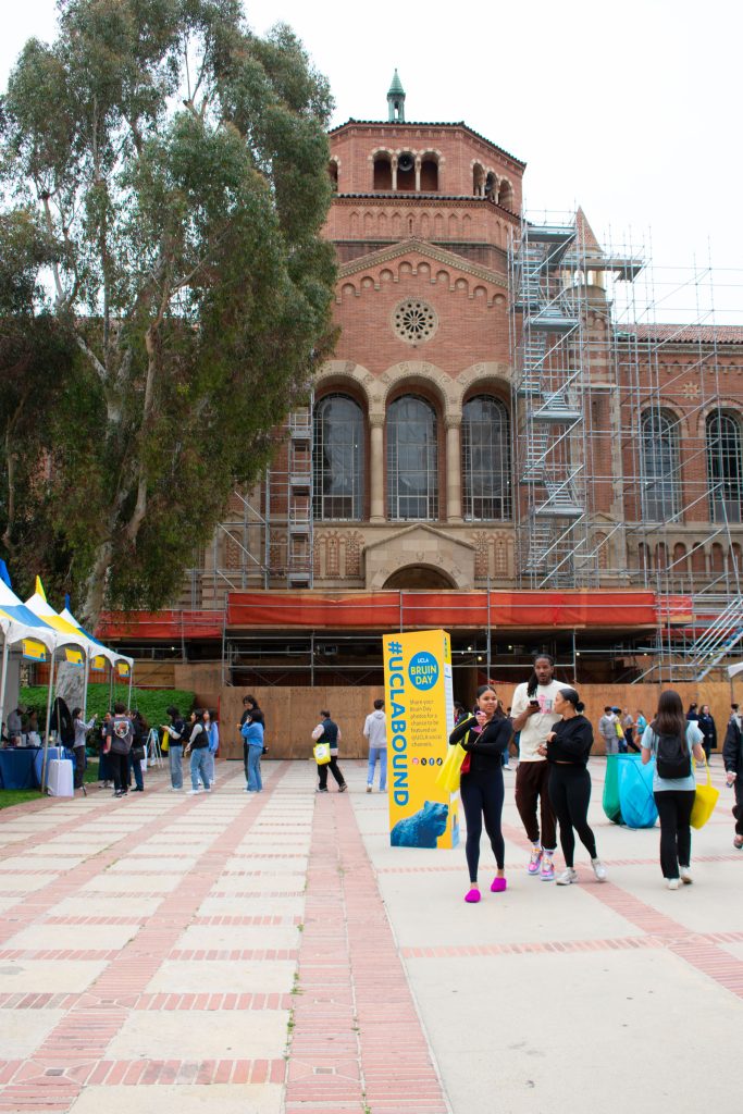 The Dickson Plaza walkway fills with students between tents and #UCLABOUND posters.