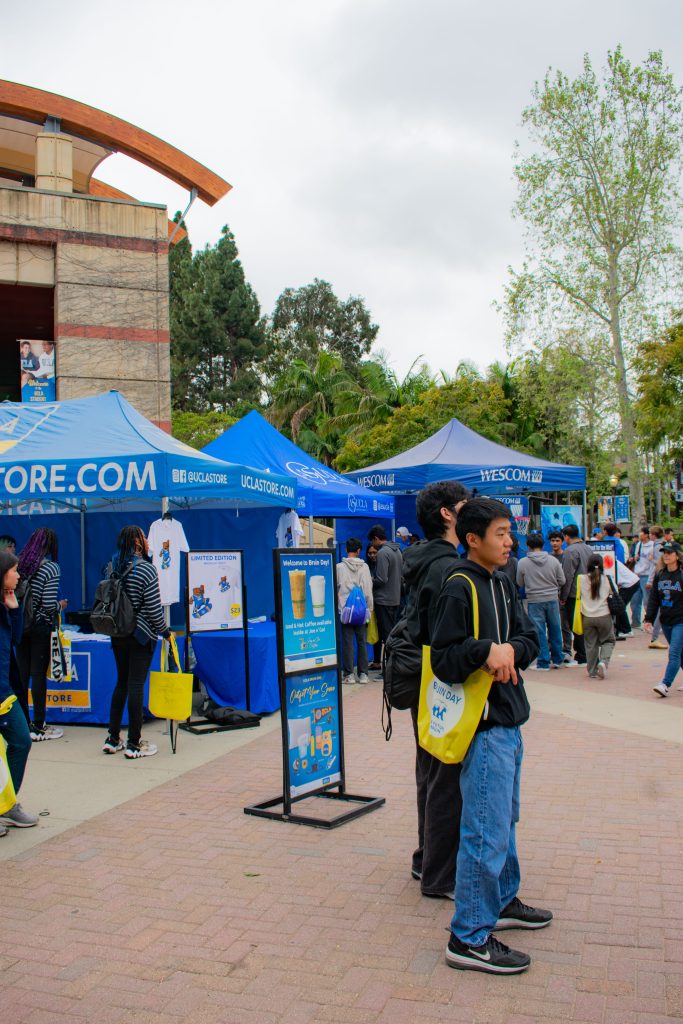 Families crowd around Wescom tents set up outside the UCLA Store and next to the Bruin Bear.