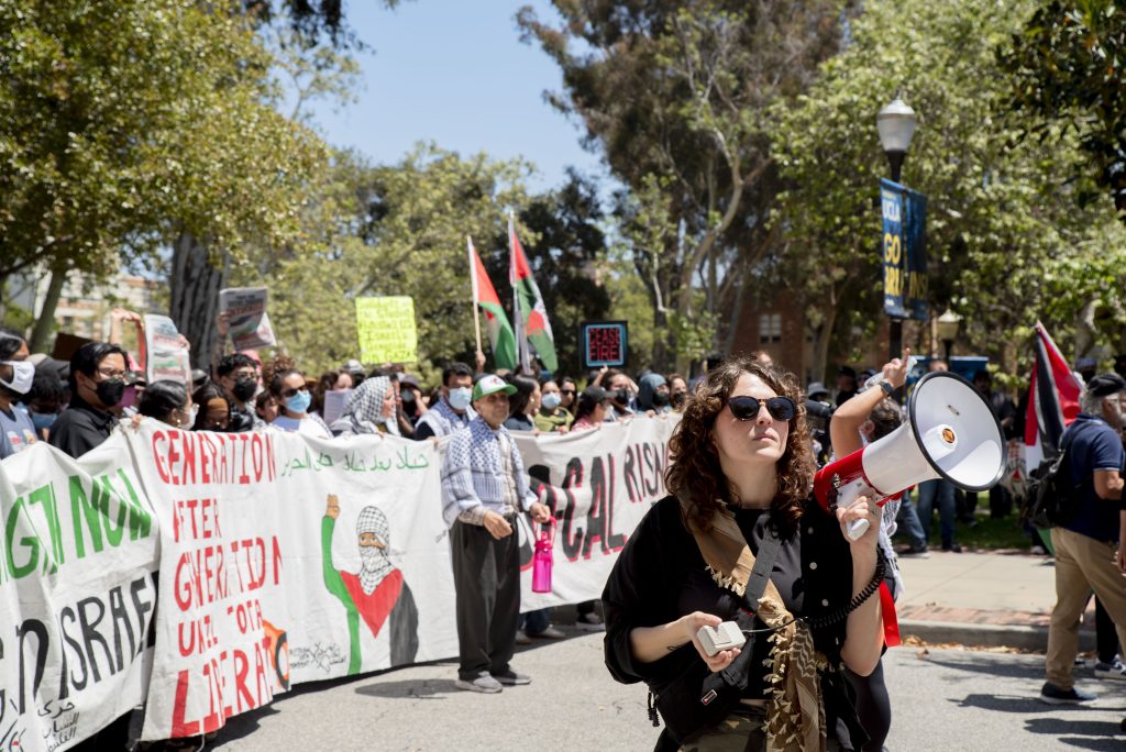 A group of pro-Palestine protesters on Portola Plaza join the demonstration after the Israeli American Council’s, or IAC's, counter-protesters take over part of Dickson Plaza. Photographed by Emily Chandler/BruinLife.