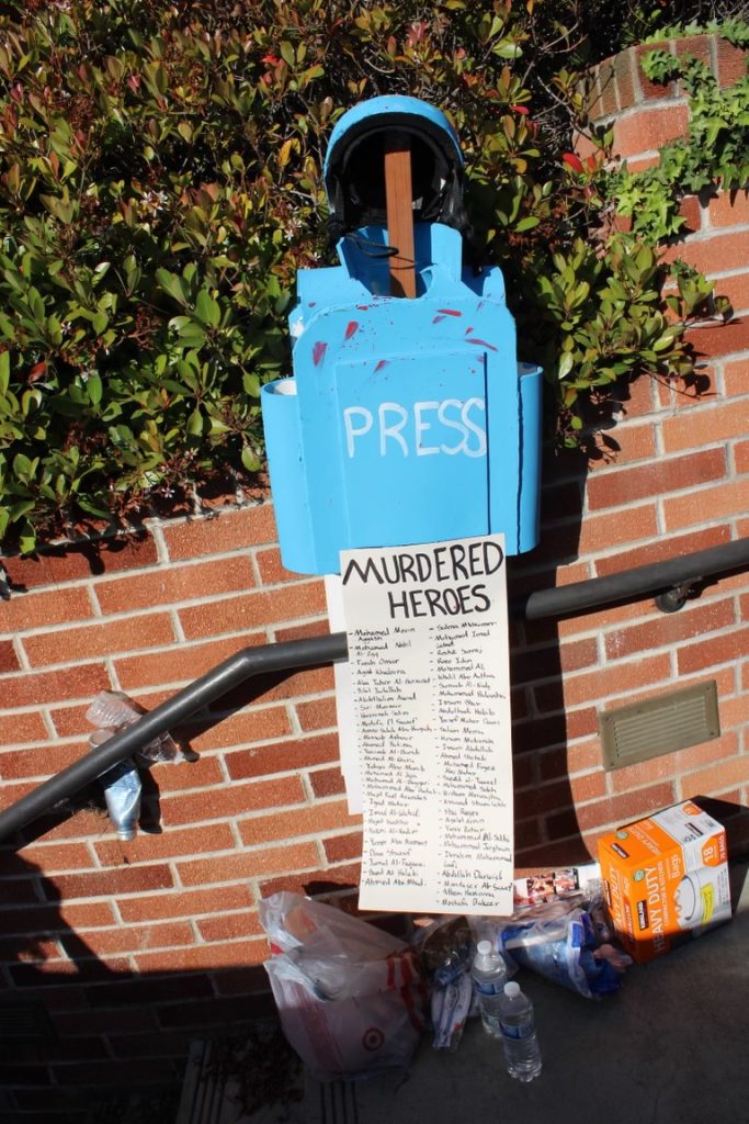 A memorial to members of the press murdered by the Israel Defense Forces is erected near the spiral staircase from Fowler Museum to Royce Hall. As of today, 97 members of the press have been confirmed to be killed while reporting the Israel-Palestine war, 92 of whom were Palestinian. Photograph provided by the Encampment Document Team.