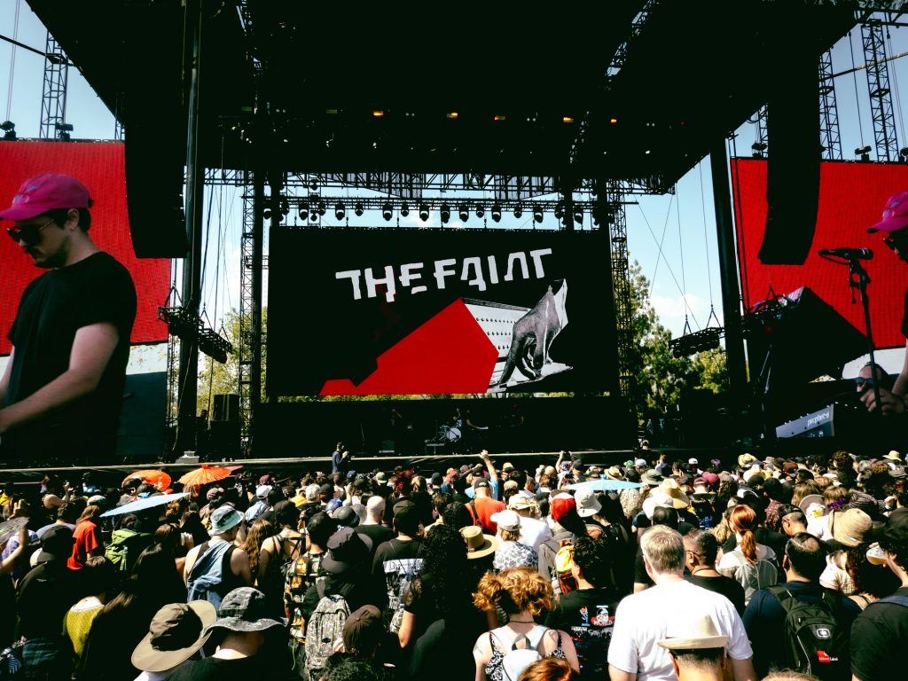 The crowd gathers to watch as The Faint plays the Outsiders stage. Photographed by Finn Martin/BruinLife
