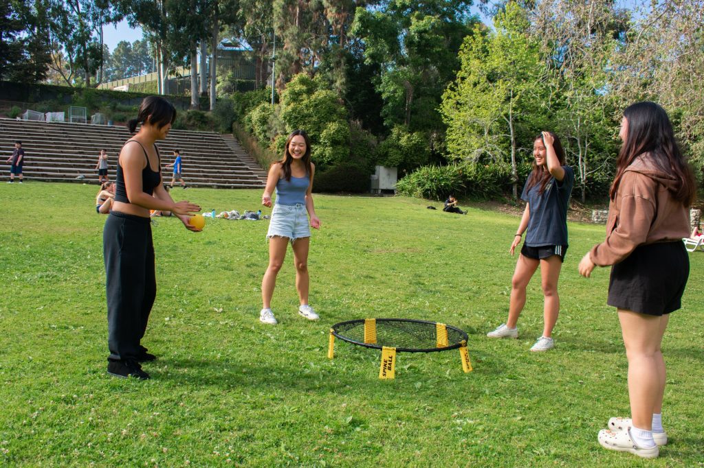 Four students play spike ball on the grass of Sunset Rec. From left to right: Janet Louie, a fourth-year student majoring in economics and minoring in Asian American studies; Katie Lai, a second-year student majoring in human biology & society and minoring in entrepreneurship; Grace Deng, a fourth-year psychobiology student; and Jolene Chan, a second-year bioengineering student.