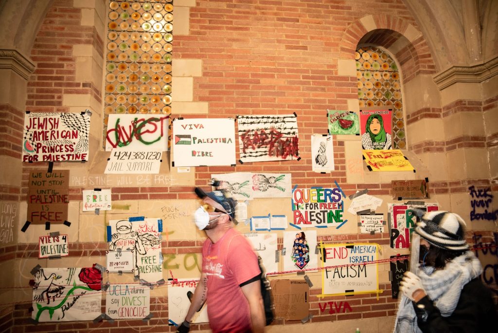 Posters, graffiti and other art made by protesters hang from the walls of Royce Hall. Photographed by Finn Martin/BruinLife.