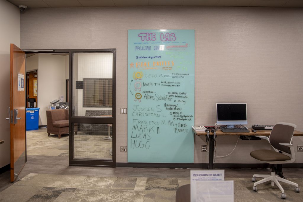 A sign with the much-awaited results of a student-organized beat battle hangs on the wall. The lab room is a student-driven space that encourages creative freedom and events such as these. Photographed by Julia Gu/BruinLife