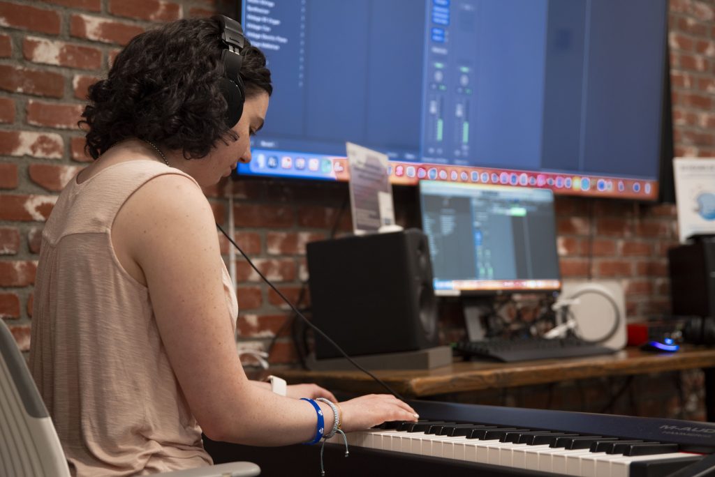 Sasha Nelson, a first-year business economics major, concentrates as she plays a song by her favorite artist by ear. "I didn&squot;t know this place existed until a few weeks ago, and I live in [De Neve] Birch," she said, "but I&squot;ve come in a few times to work on the song." Although she does not have formal experience with music, the lab space allows her to explore the music she likes in a way she likes. Photographed by Julia Gu/BruinLife