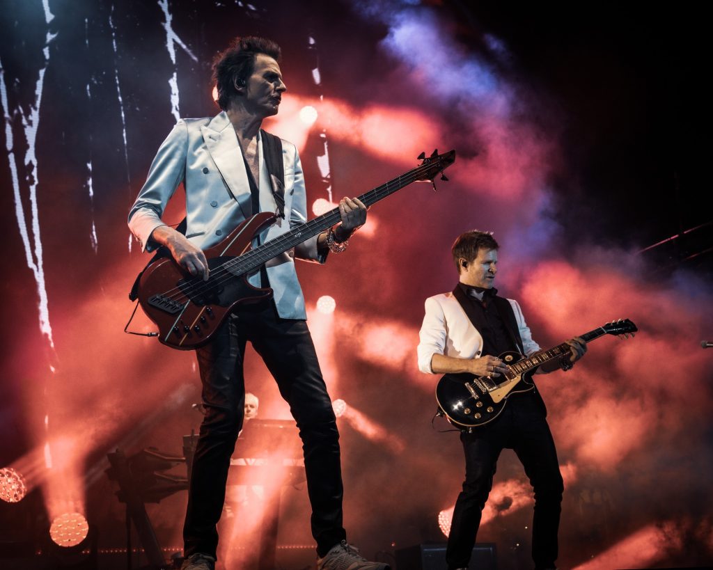 Duran Duran guitarists mimic each other&squot;s movements as they play their classic hit "The Wild Boys." Photographed by Cathryn Kuczynski/BruinLife