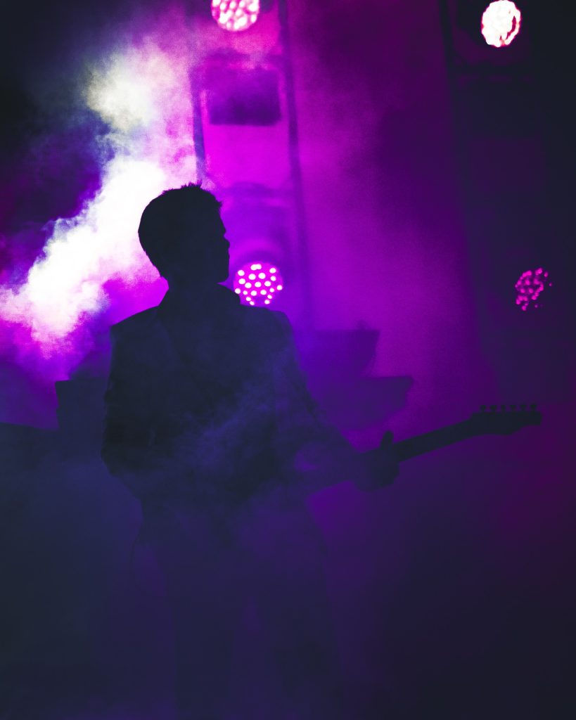 Duran Duran guitarist Dominic Brown emerges from a foggy haze as the band makes their Cruel World debut. Photographed by Cathryn Kuczynski/BruinLife