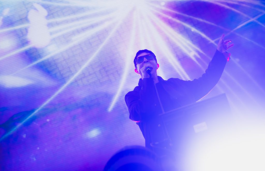 Marc Almond of Soft Cell fronts the band's performance on the Outsiders stage with vibrant accompanying visuals. Photographed by Cathryn Kuczynski/BruinLife