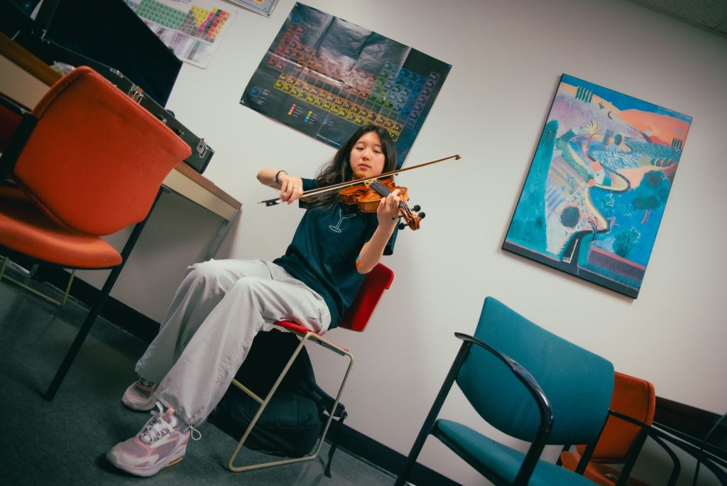 Amber Chen, a first year violinist majoring in English, was originally classically trained but has since shifted to add her strings to The Sinking Ducks.  Photographed by BruinLife/Finn Martin