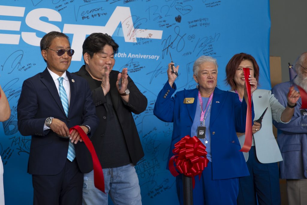 The mayor of Buena Park, Susan Sonne, middle right, and the CEO of Dispatch, Myeong Gu Lee, middle left, celebrated the ribbon cutting ceremony. Photographed by Caleb Velasquez/BruinLife.