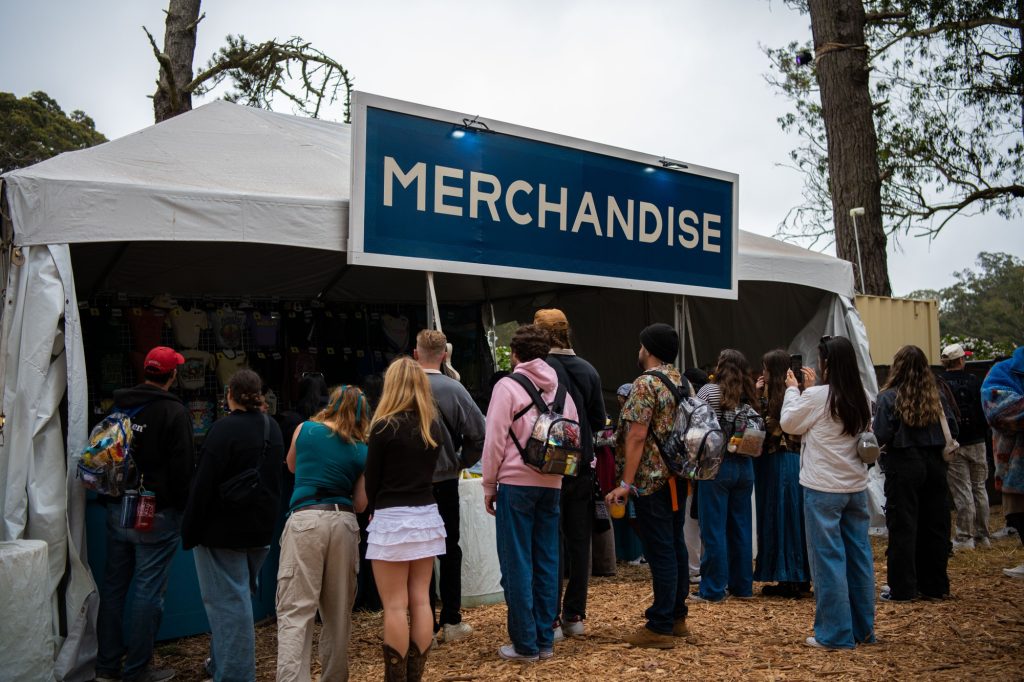 Festivalgoers wait in line at one of three merchandise booth, eager to get one of the many exclusive "Outside Lands" items for sale. Photographed by Caleb Velasquez/BruinLife.