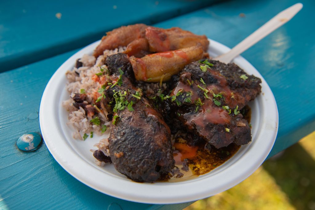 The Jerk Chicken Meal from Peaches Patties fills out the entire plate, an uncommon scene for festival foods. Photographed by Caleb Velasquez/BruinLife.