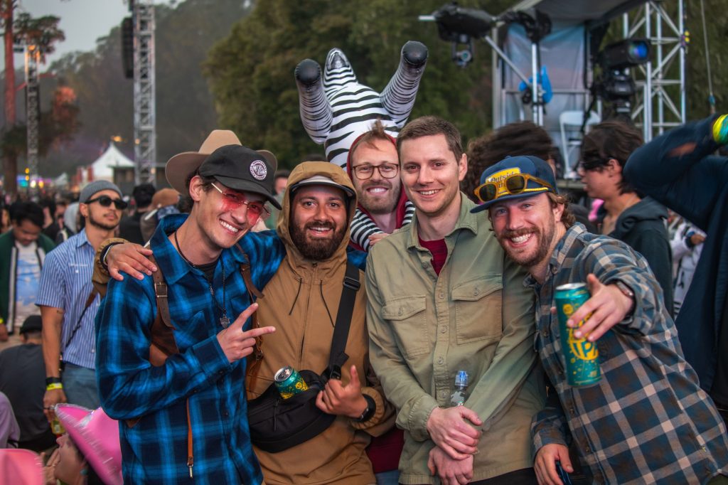 A group of attendees pose for a picture as they wait for Kaytranada's set. One attendee held an inflated zebra on his back for their group to find each other in case any of them get separated. Photographed by Caleb Velasquez/BruinLife.