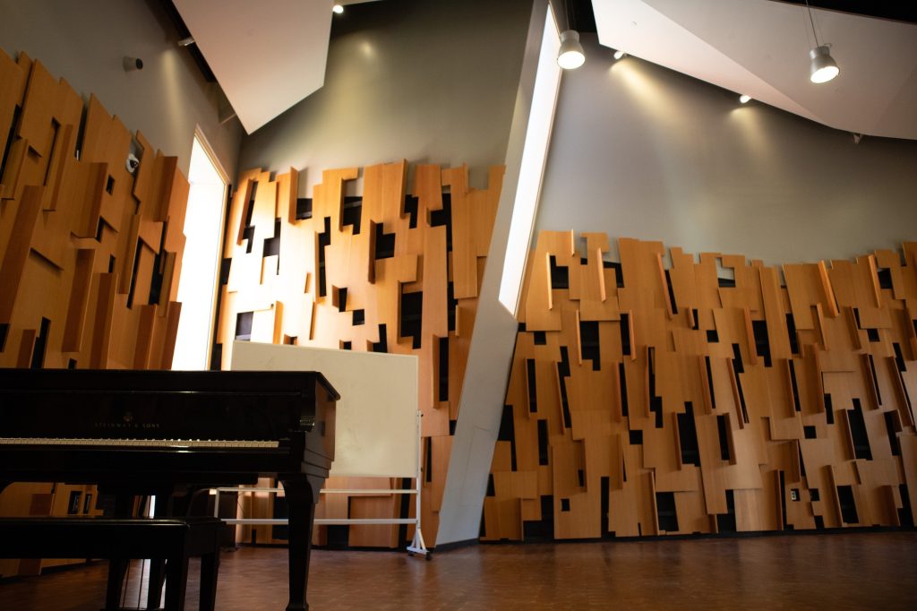 Inside the UCLA School of Music, a solitary piano awaits its next maestro, offering a silent promise of melodies yet to be birthed in this intimate rehearsal sanctuary. Photographed by Juan Cesar Perez/BruinLife