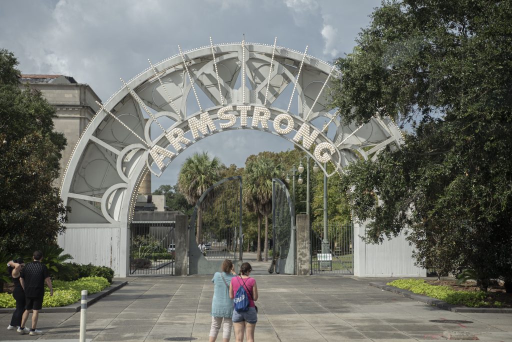 Travelers stop in front of the Louis Armstrong Park in City Park. The iconic archway is an eye-catching entryway for the park which honors Louis Armstrong. Photographed by Emily Chandler/BruinLife.