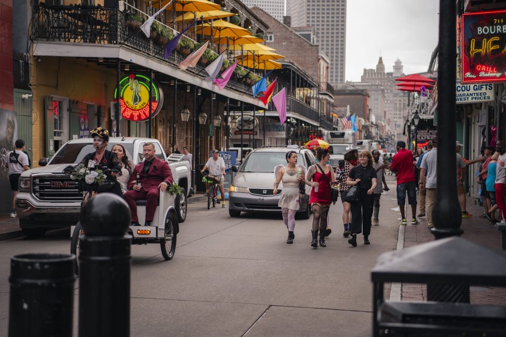 People walk down Bourban Street in Halloween costumes and explore the New Orleans atmosphere. Bourban Street in the French Quarter has been one of the liveliest streets in the city, where one can find bars, live music, crazy costumes and amazing food. Photographed by Emily Chandler/BruinLife.