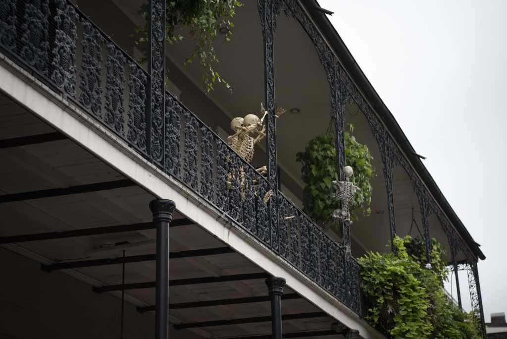 Skeletons clime the railings of balconies above the streets of the French Quarter. Halloween decorations were strewn throughout the city. Photographed by Emily Chandler/BruinLife.