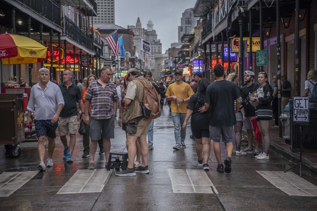 A couple stops to get their photo taken by a man selling Polaroids on the street. People flooded through the streets in the French Quarter, enjoying the lively atmosphere and scenic streets. Photographed by Emily Chandler/BruinLife.