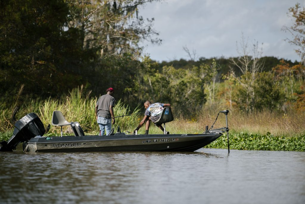 Two New Orleans natives take to the swamp for an early morning fishing trip. Photographed by Emily Chandler/BruinLife.