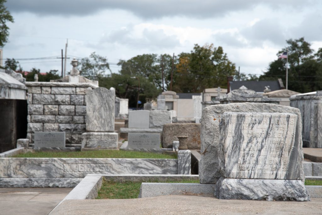 Graves stand in a New Orleans cemetery. Most graves in the city were entombed in cement or raised to stand above ground, as most cemeteries in the city fall below sea level due to the dredging of new lands in the city's early history.  Photographed by Finn Martin/BruinLife.