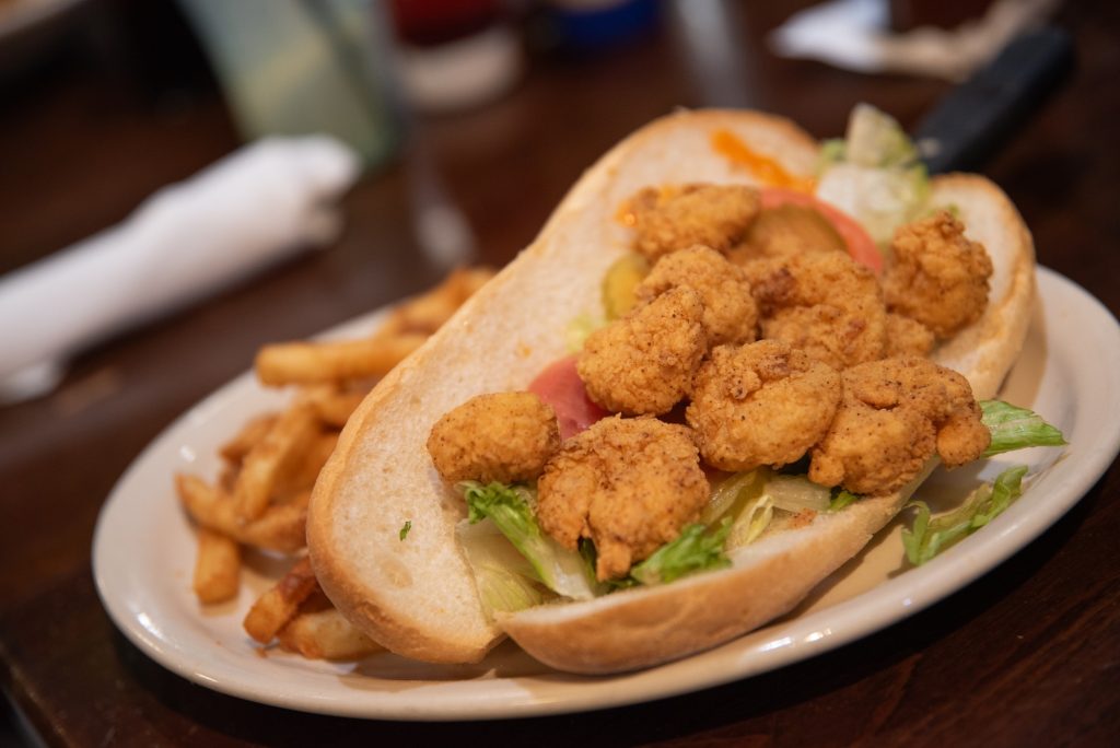 Crunchy and few, the fried shrimp offered in the Creole House's Po-Boys underwhelms but does not disparage this classic sandwich.  Photographed by Finn Martin/BruinLife.