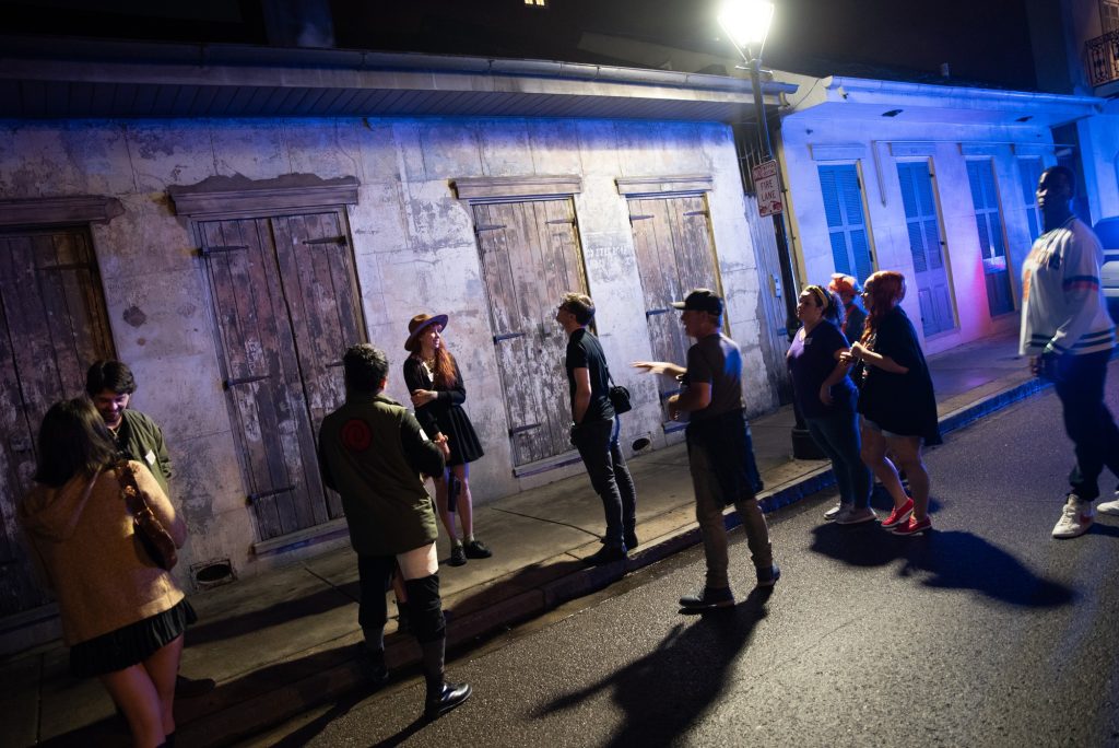 Tour guide Dane points to an old tenement home near Toulouse Street in New Orleans.  Photographed by Finn Martin/BruinLife.