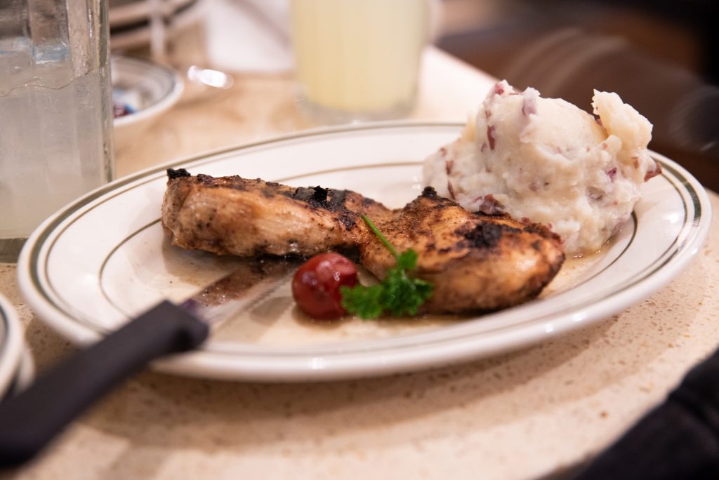 The grilled chicken comes with a potato blended with sliced pieces of ham.  Photographed by Finn Martin/BruinLife.