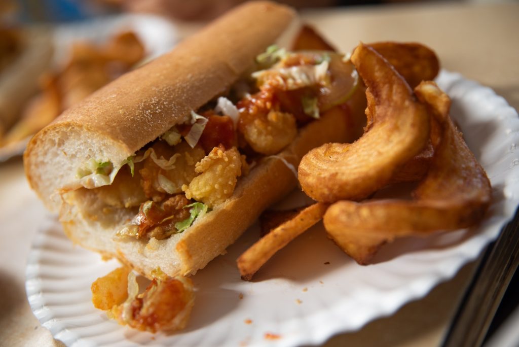 Simple, fresh and delicately dressed: Domilise's offers a Po-Boy and curly fry combination in a cozy, hometown feeling setting.  Photographed by Finn Martin/BruinLife.