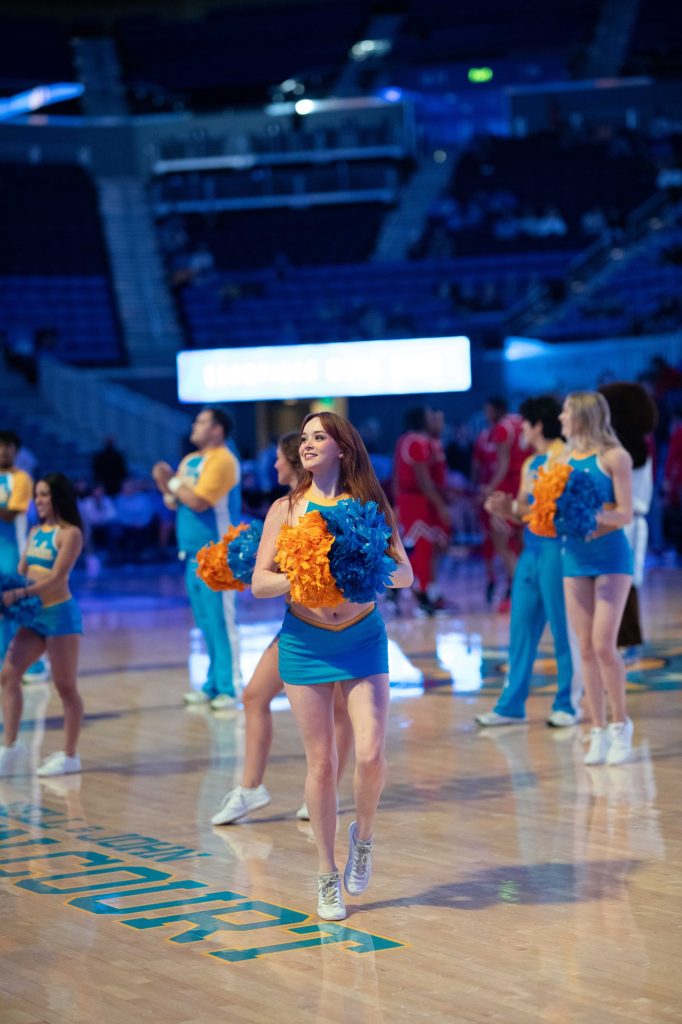 UCLA Cheer energize the crowd at Pauley Pavilion during a Bruins basketball game, showcasing school spirit with dynamic routines and vibrant colors. Photographed by Ryan Zhang/BruinLife