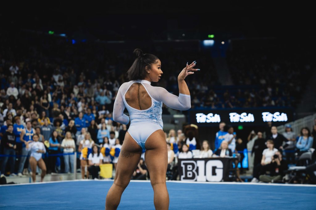 Jordan Chiles dazzles the crowd as she begins her floor routine-- the team's final exercise of the night. Photographed by Cathryn Kuczynski/BruinLife