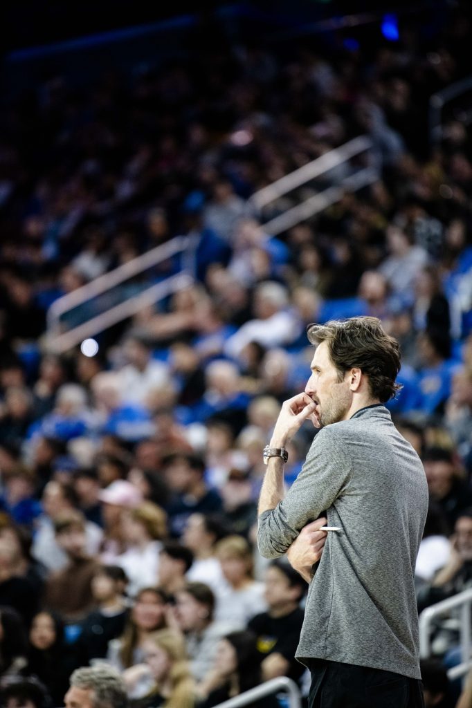 Coach Nick Vogel watches closely as UCLA serves on game point of set three. Vogel is a UCLA men's volleyball alumni, playing from 2009 to 2012. Photographed by Ryan Zhang/BruinLife.