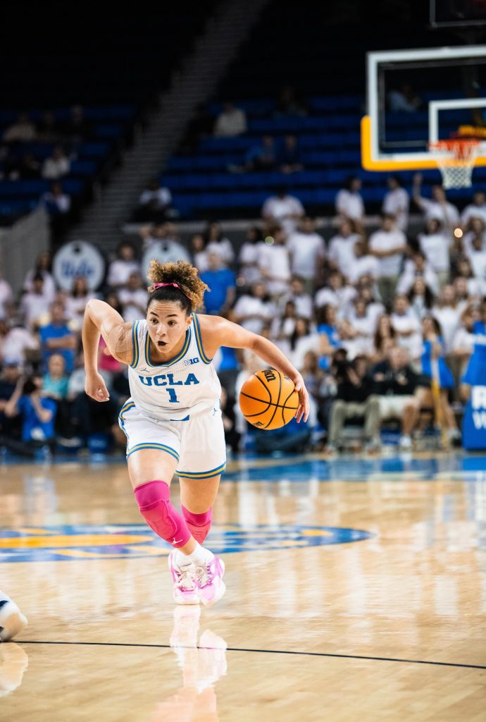 UCLA #1 Kiki Rice drives to the paint, blowing past Illinois defense. Photographed by Ryan Zhang/BruinLife