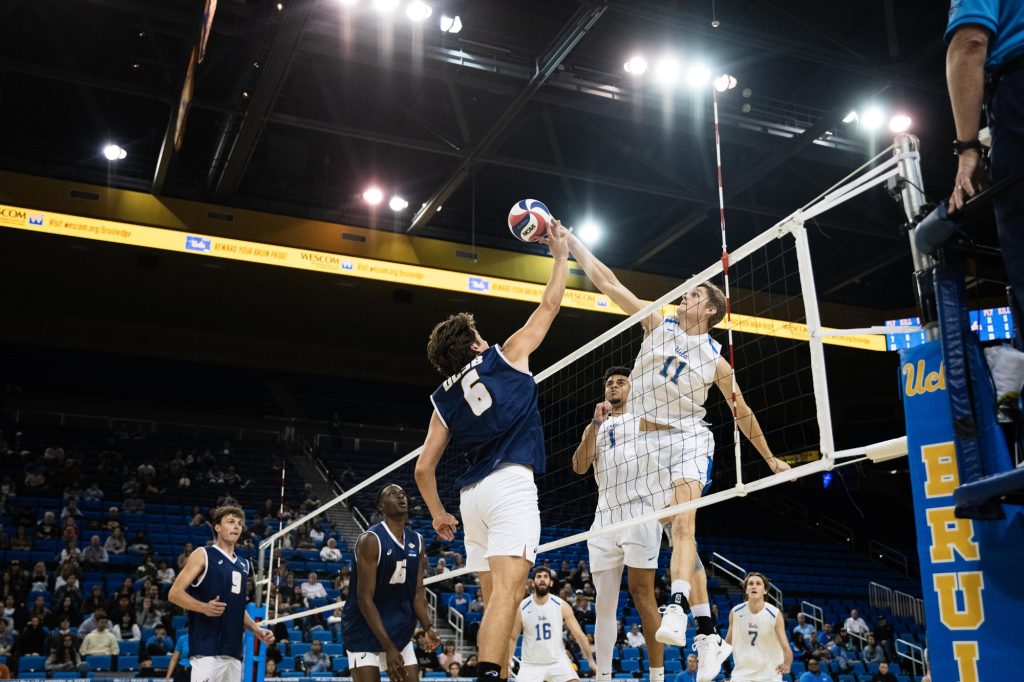 UCSB #6 Jack Walmer attempts to block UCLA #11 Cooper Robinson's tip over the net. Photographed by Ryan Zhang/BruinLife