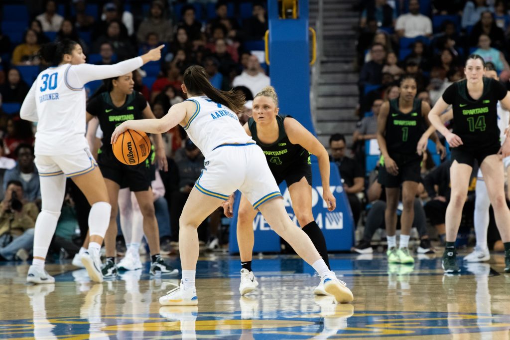 UCLA’s #7 Elina Aarnisalo has the ball, facing off against a Michigan State defender