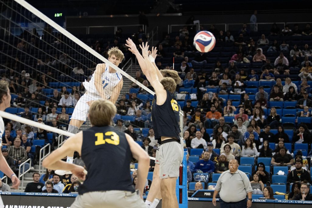 Cooper Robinson executes an impressive kill in the second set. The outside hitter totaled 4 kills, 1 ace, and 5 blocks across the three sets on Saturday night. Photographed by Julia Gu/BruinLife