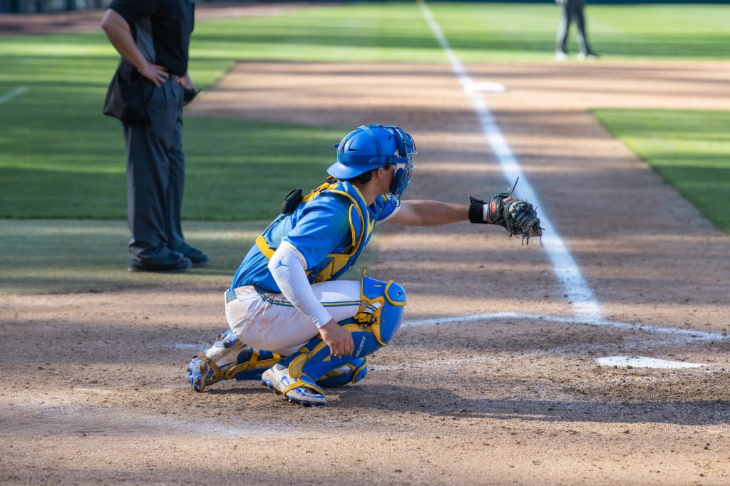 UCLA Catcher #8, Kasen Khansarinia, is seen practicing in between innings. Today was one of his first plays.