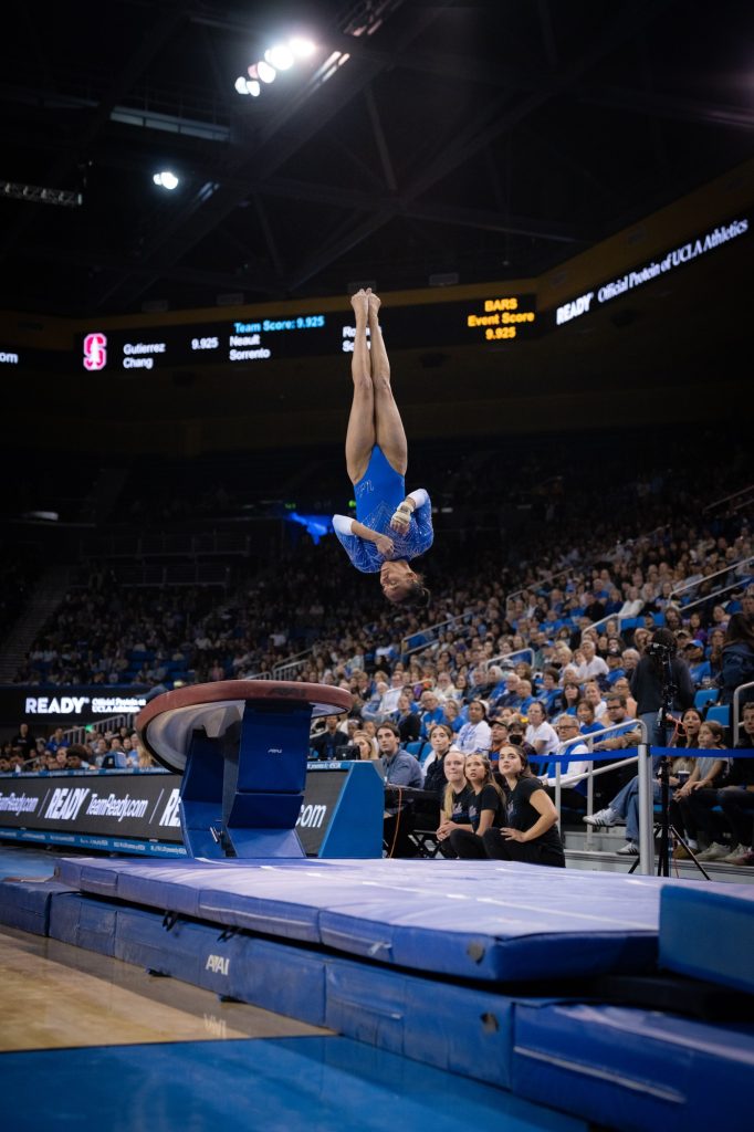 Mika Webster-Longin soars as she performs her vault routine and earns a 9.675 from the judges. Photographed by Cathryn Kuczynski/BruinLife.