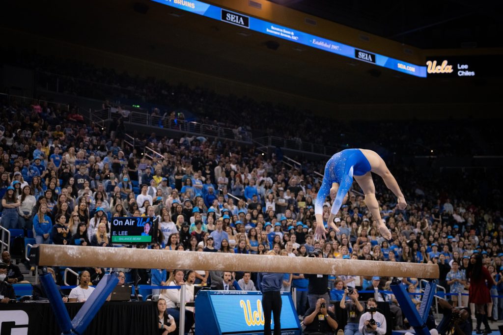 Senior Emily Lee delivers an exemplary beam routine, performing at the last home meet of her UCLA career. Photographed by Cathryn Kuczynski/BruinLife.