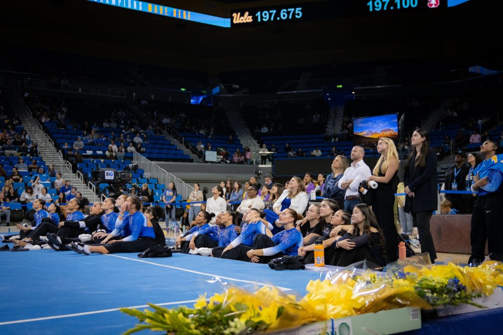 The entirety of the UCLA women’s gymnastics team gathers to watch a congratulatory compilation for this year’s seniors. Photographed by Cathryn Kuczynski/BruinLife.