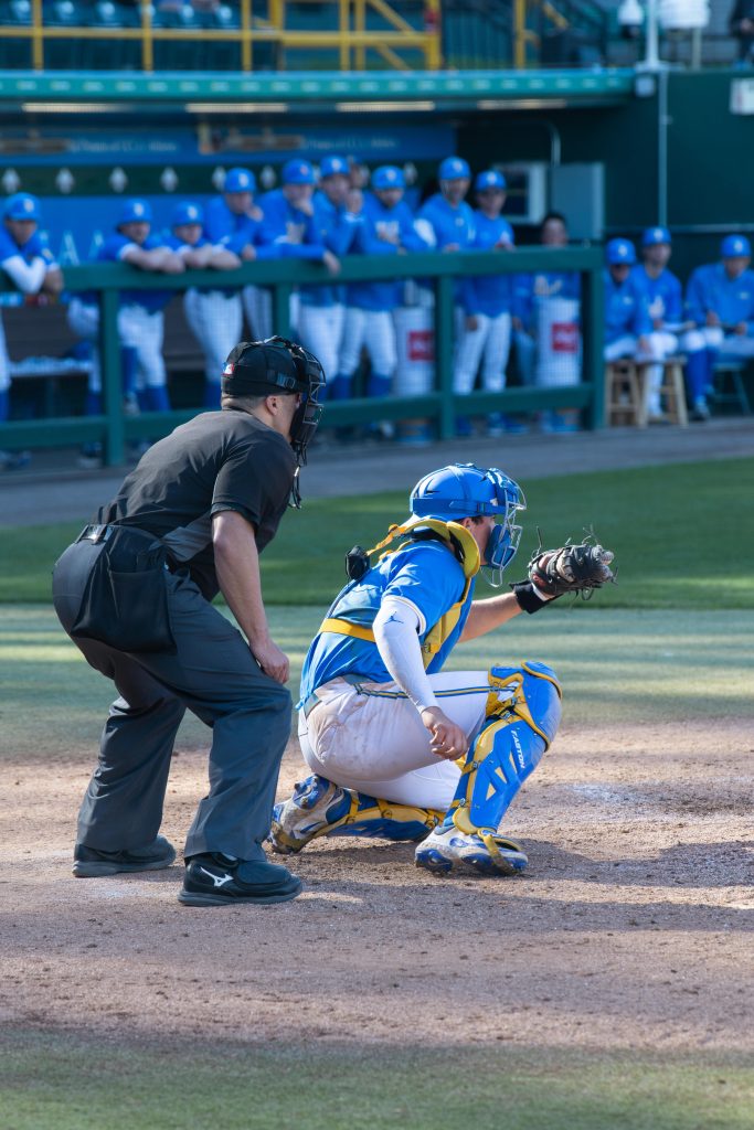 UCLA Catcher positions himself to catch the UCLA pitcher's fast pitch. Many strikes were in today's game; in which catchers readied themselves attentively.